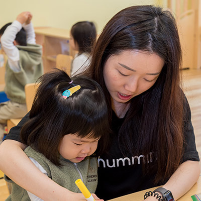 Preschool Teacher Shows Child How to Draw at Rothewood Academy