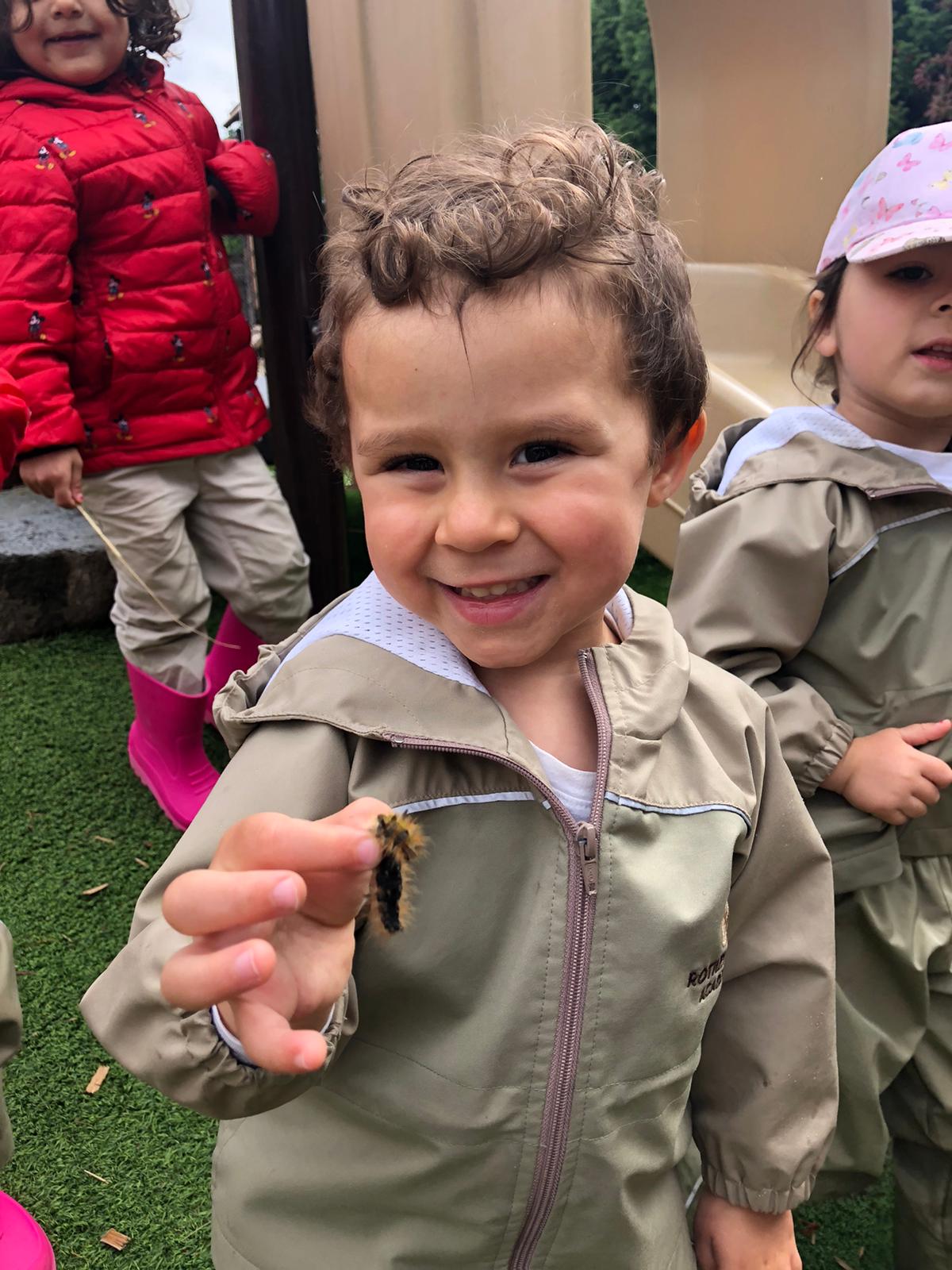 Girl looking at beetle | Experiential Learning Adventures